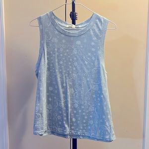 L girls tank top. Light blue with white patterns.